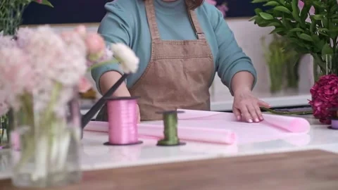 Inside of charming flower shop, creative female business owner expertly arranges Stock Footage 237633161