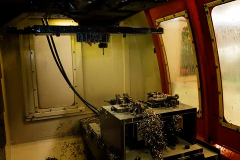 Inside CNC machining Center machine cutting part in Jig with coolant Stock Photos