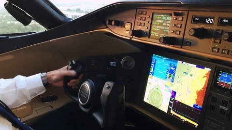 Inside a cockpit hands of a pilot and view of approaching the runway Stock Footage