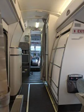 Inside of a commercial plane. Front view of the pilots in a cockpit and cabin Stock Photos