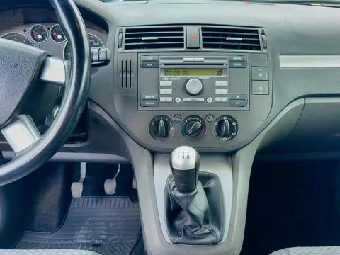 Inside a compact car, a clean dashboard is displayed featuring control knobs, Stockfoto's