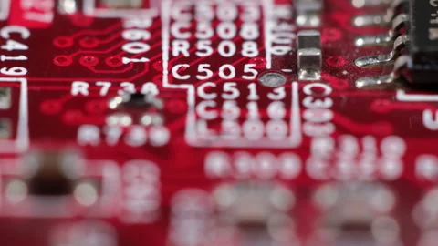 Inside computer red circuit board with transistors and white markings Stock Footage 141345666