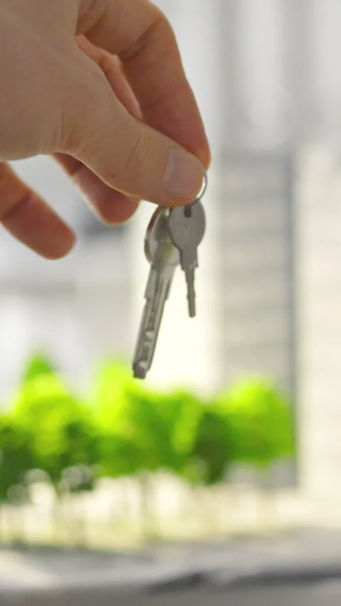 Inside a construction companys office a real estate manager hands the apartm Stock Footage 338200656