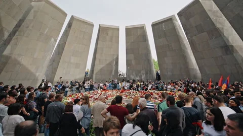 Inside the crowded Armenian Genocide Memorial surrounded by flowers Stock Footage 189767362