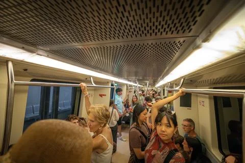 Inside a crowded metro Line C train car in Rome. Photos