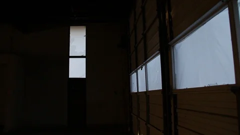 Inside dark garage pans 180 to trash dump outside Stock Footage 95112024