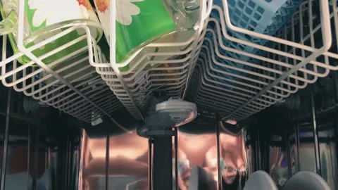 The inside of the dishwasher. loading dishes into the dishwasher. Stock Footage 134705631
