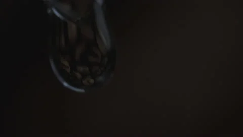 Inside a drop of water there are coffee beans on a black background. Stock Footage 187495604