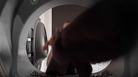 Inside Dryer View of a woman loading laundry into the dryer. Routine housework. Vídeos de archivo 263068467