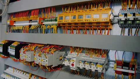 Inside of electrical control panel with multiple switches and wires Stock Footage 120231331