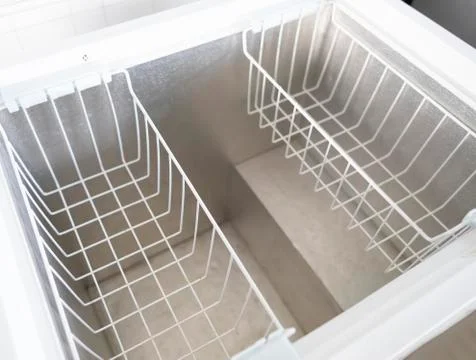 Inside Of An Empty Freezer With Two Baskets Stock Photos