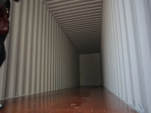 Inside an empty shipping container. Man is checking  a container Video stock 76528547