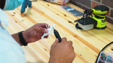 Inside fab-lab sanding white 3d printed object Stock Footage 163255542