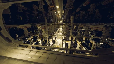 Inside a futuristic industrial facility with complex machinery at night Vidéo 303806805