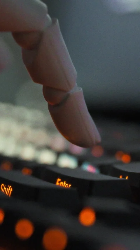 Inside a futuristic programming lab a robotic arm interacts with a keyboard Stock Footage 347278176