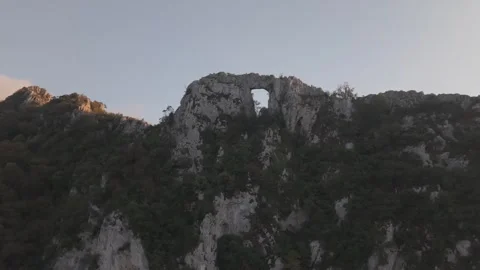 Inside Giant Stone Arch Portal On Mountain Peak Sunset 4K 60fps Vídeo Stock 337409849