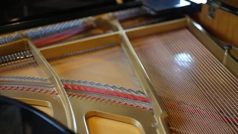 Inside of grand piano focusing on strings and frame. Strings stretched across Stock Footage 293851189