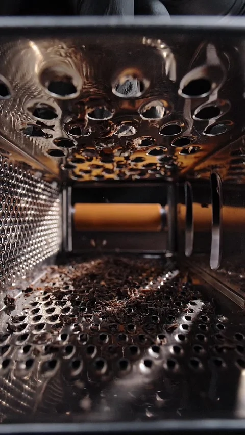 Inside a handheld kitchen grater while making chocolate shavings. Stock Footage 281668822