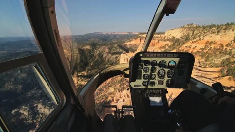 Inside helicopter cockpit flying over desert canyon Stock Footage 128779699