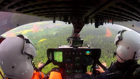Inside Helicopter Cockpit with Pilot in Flight - Over shoulder view Stock Footage 166914276