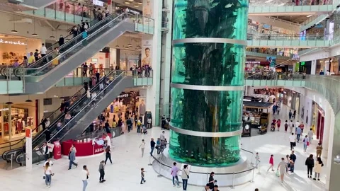 Inside a huge shopping mall. Top view of escalators, crowd of people Stock Footage