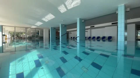 Inside indoor pool with blue water in backyard of country house cottage Stock Footage 327027354