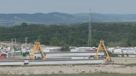 Inside An Industrial Fabrication Yard Where Giant Yellow Cranes Transport A.. Stock Footage 338186020
