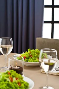 Inside interior table setting with beautiful salad Stock Photos