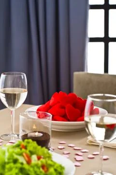 Inside interior table setting with beautiful salad and one plate of hearts Stock Photos