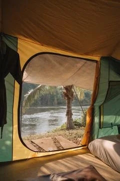 Inside of large comfortable camping tent on campground in the tropical fore.. Stock Photos