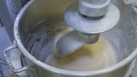 Inside a large dough mixing machine sprinkling flour 4K Stock Footage 93365272