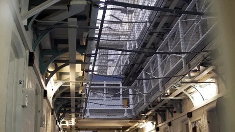 Inside Large Prison Block, Cinematic Reveal Of Locked Up Cells, 4K Incarceration Stock Footage