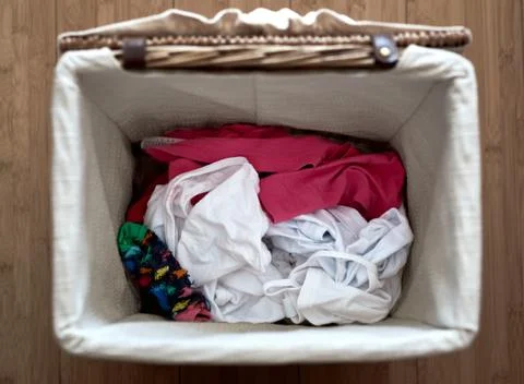 Inside of a laundry basket with different clothes Stock Photos