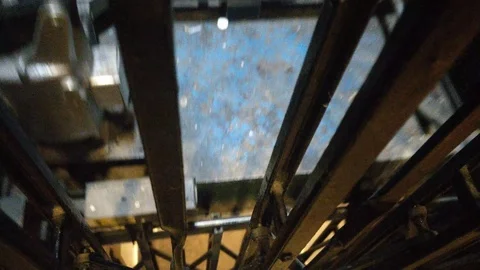INSIDE LIFT SHAFT AS ELEVATOR MOVES UP AND COMES TO STOP Stock Footage 126591443