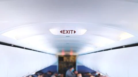 The inside of a light-filled tunnel full of masked men sitting near white Stock Photos