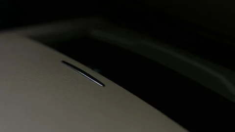 Inside a luxury car interior. A man closes the cup holder with his hand. 4K 스톡 동영상 145551970