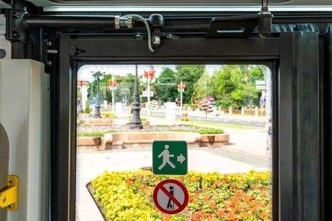 Inside a modern electric bus. View of closed doors of moving public transport Stock Photos