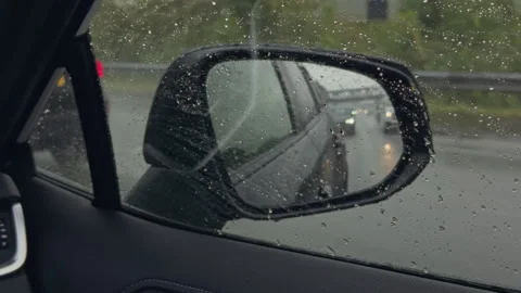 Inside a Moving Car Driving in Rain with Raindrops Streaking Across Side Stock Footage 346000074