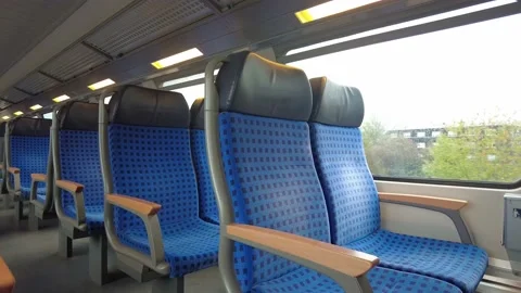 Inside of a moving train with blue chairs, still shot Stock Footage 229889372