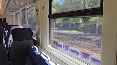  Inside a moving train with seats and windows showing passing scenery, in.. Stock Footage 341877948