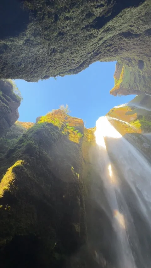 Inside the narrow canyon of Gljufrabui waterfall with water cascading from above Stock Footage 331560018
