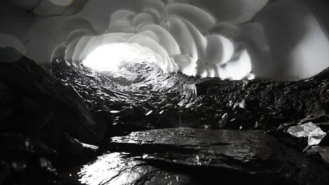 Inside a natural snow cave melting and dripping water near Jungfrau region Stock Footage 79809199