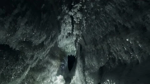 Inside night winter frozen cave ice floes, icicles on walls Baikal lale landmark Stock Footage 165664103