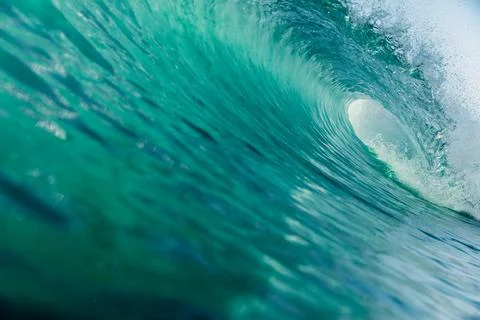 Inside ocean barrel wave with sunlight and turquoise water texture Stock Photos