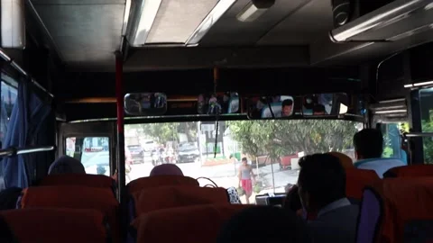 The inside of a old bus with passenger sitting in the seats Stock Footage 218365058