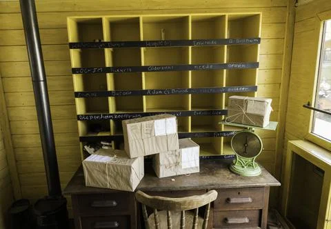 The inside of an old mail train with desk and sortinh boxes Stock Photos