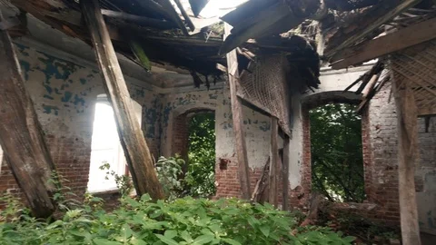 Inside old ruined building with collapsed roof and overgrown with grass Video stock 93501417