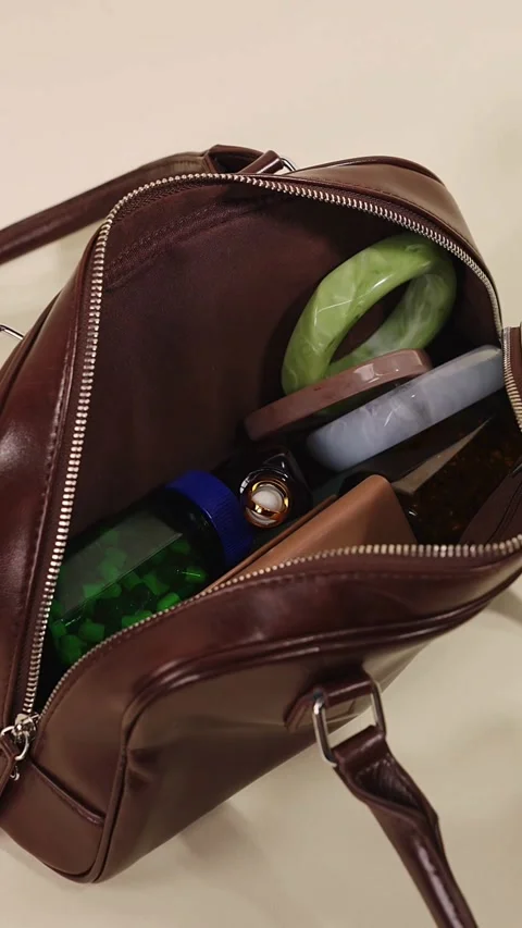 Inside an open brown leather bag with various accessories Stock-Footage 331773989
