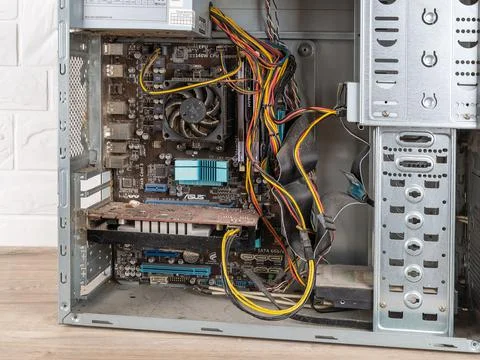 Inside of open old dusty pc system unit before cleaning on a desk. Stock Photos