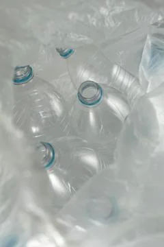 Inside an open transparent plastic bag with several empty bottles of liter an Stock Photos